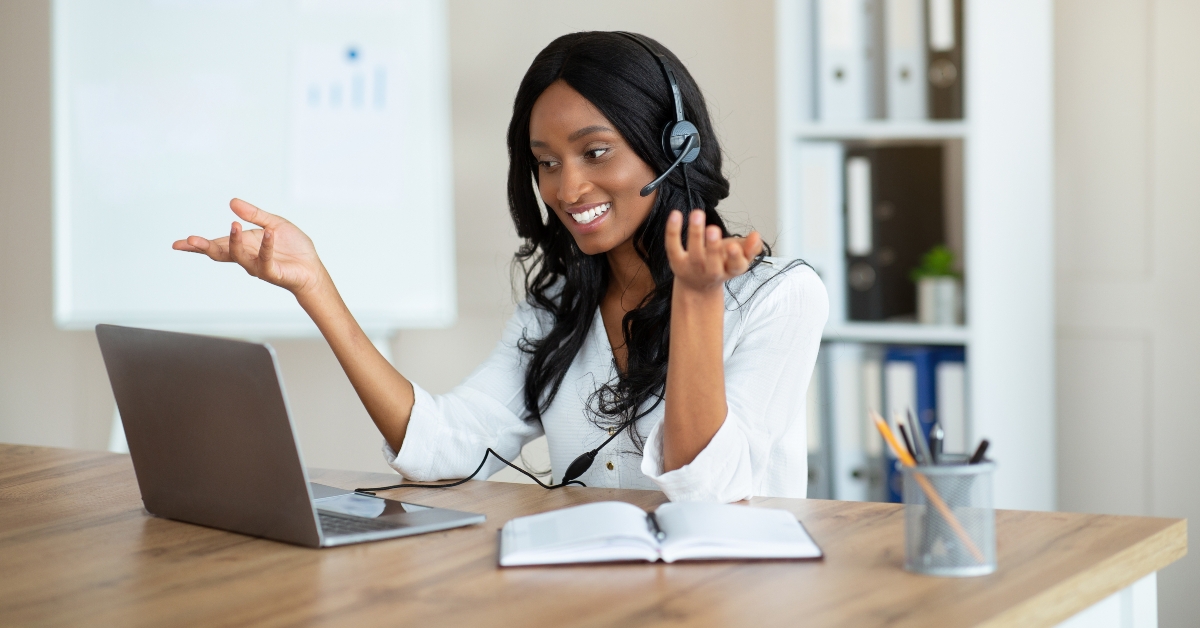 office worker in headset speaking with business partner