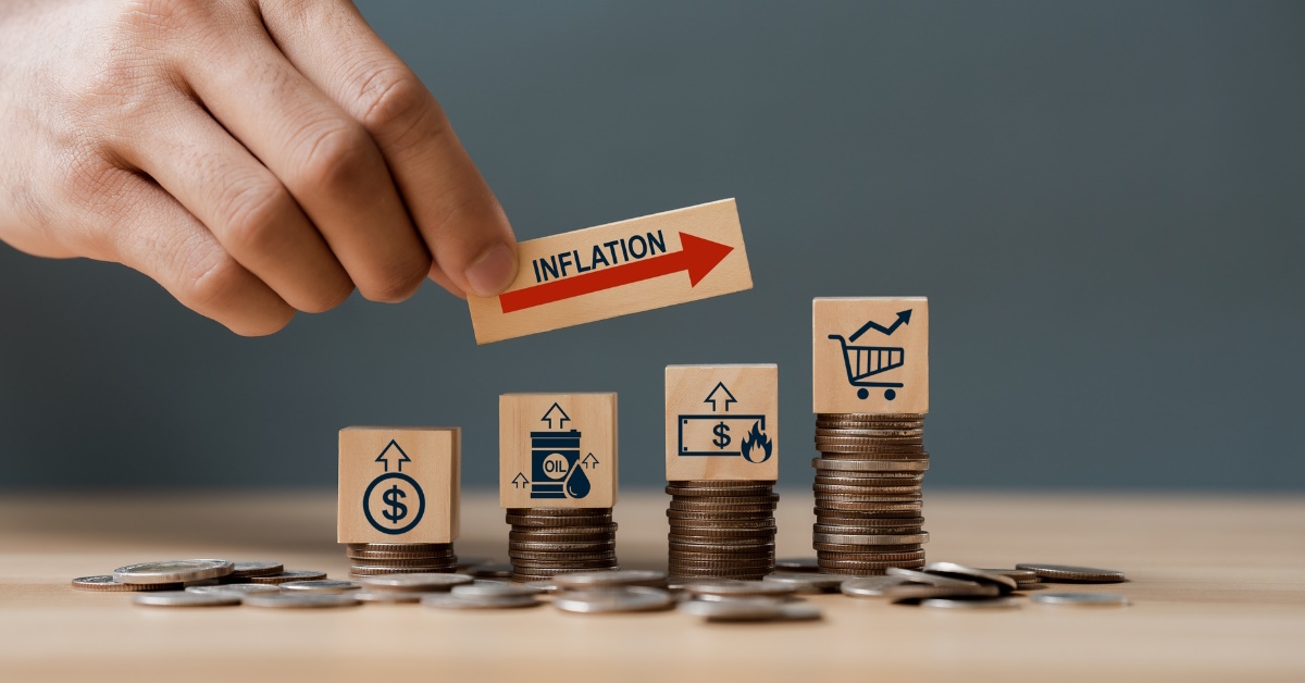 hand holding inflation label over pennies on table 