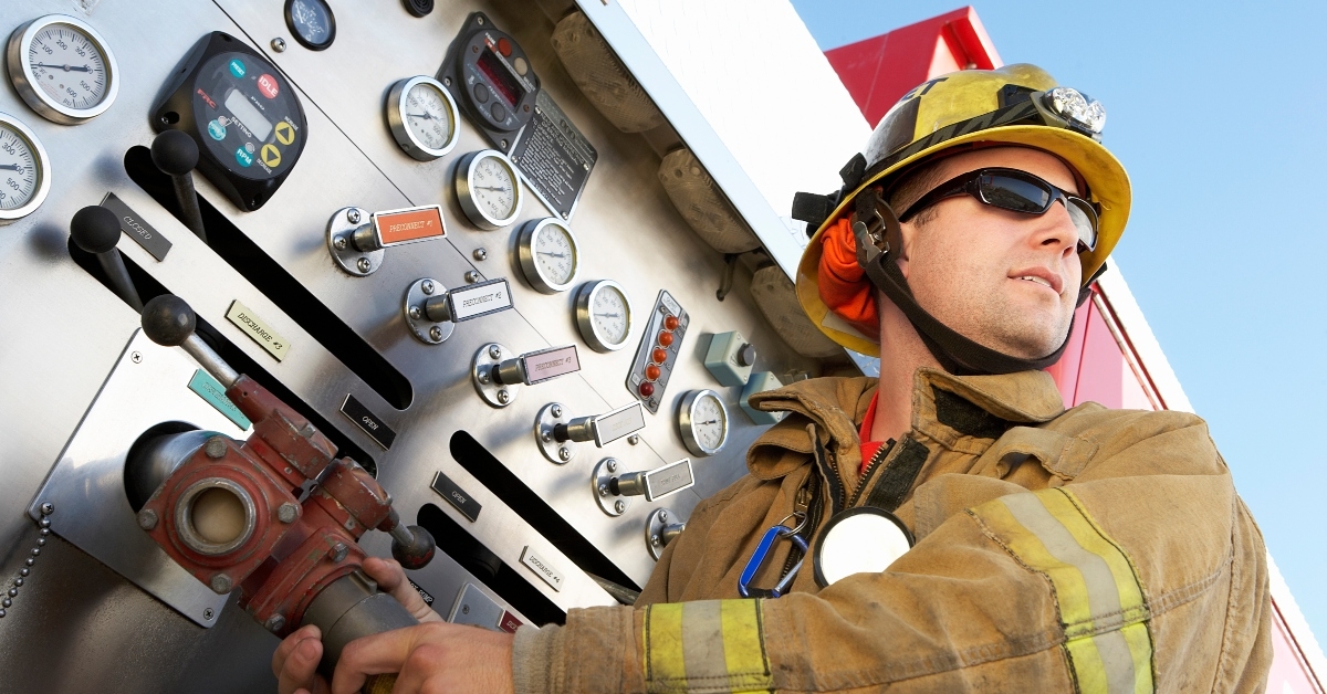 Fire-fighter grabbing hose from Fire truck