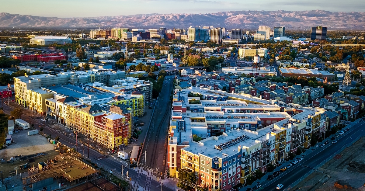 buildings and streets full of crowd in san jose at sunset time