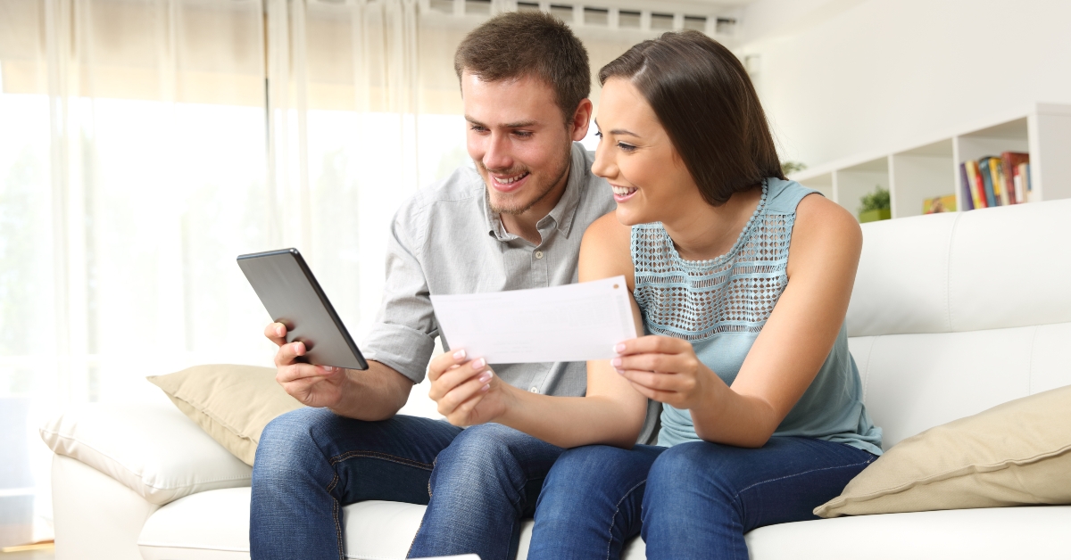 happy couple checking bank account online