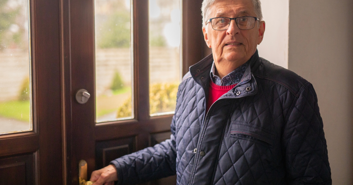 old man opening the door