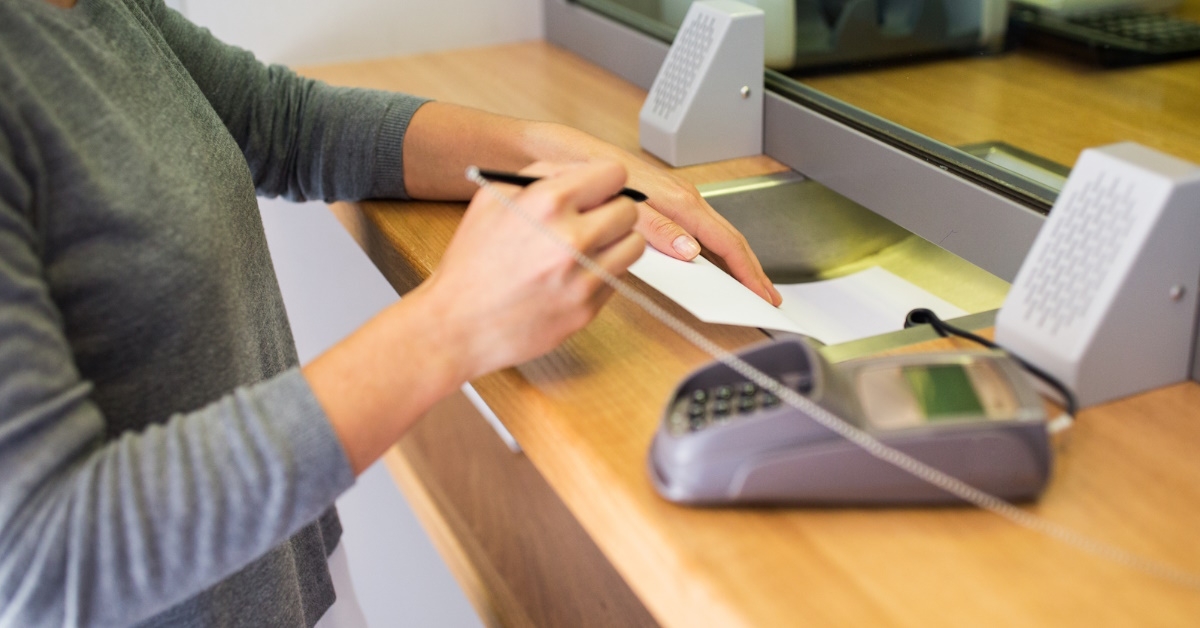 woman signing bank receipt  