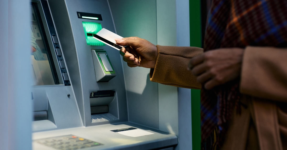 woman using atm late at night