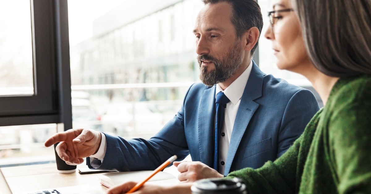 male manager with assistant taking notes at work