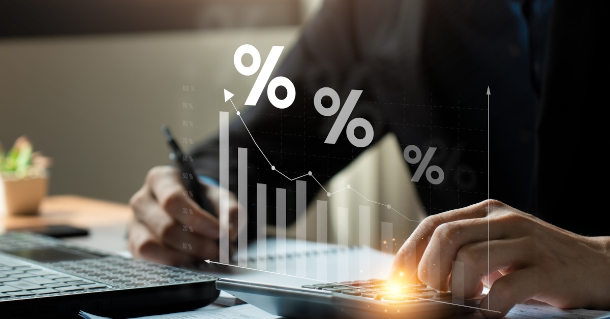 man calculating and writing interest and return on investment 