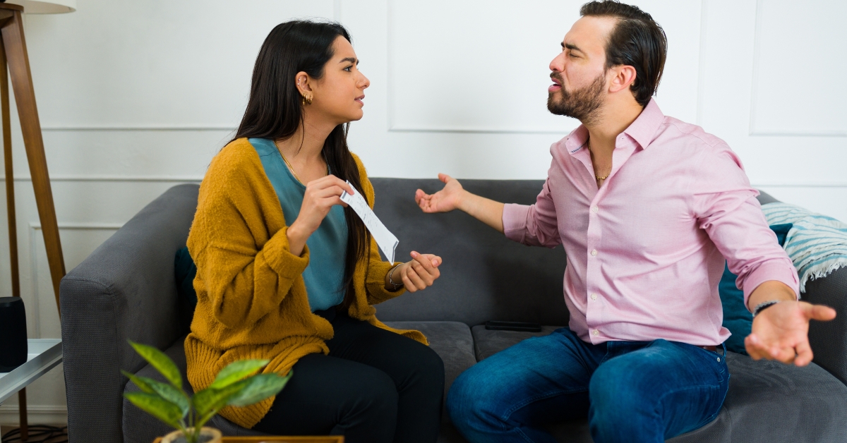 angry married couple arguing about their finances 