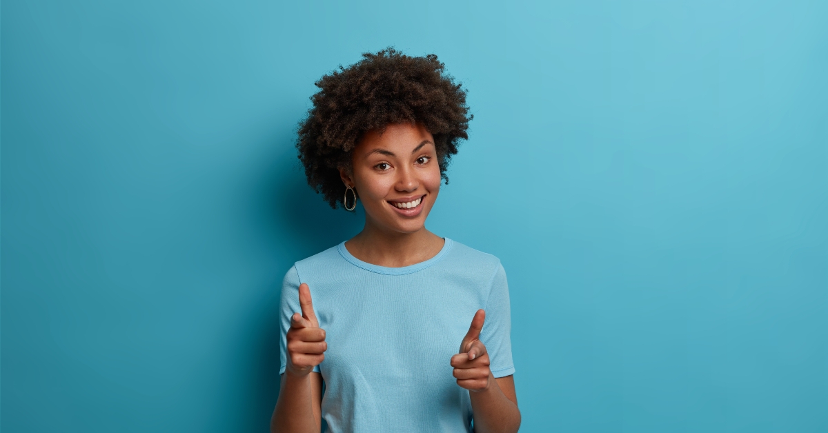 dark-skinned girlfriend makes finger gun gesture
