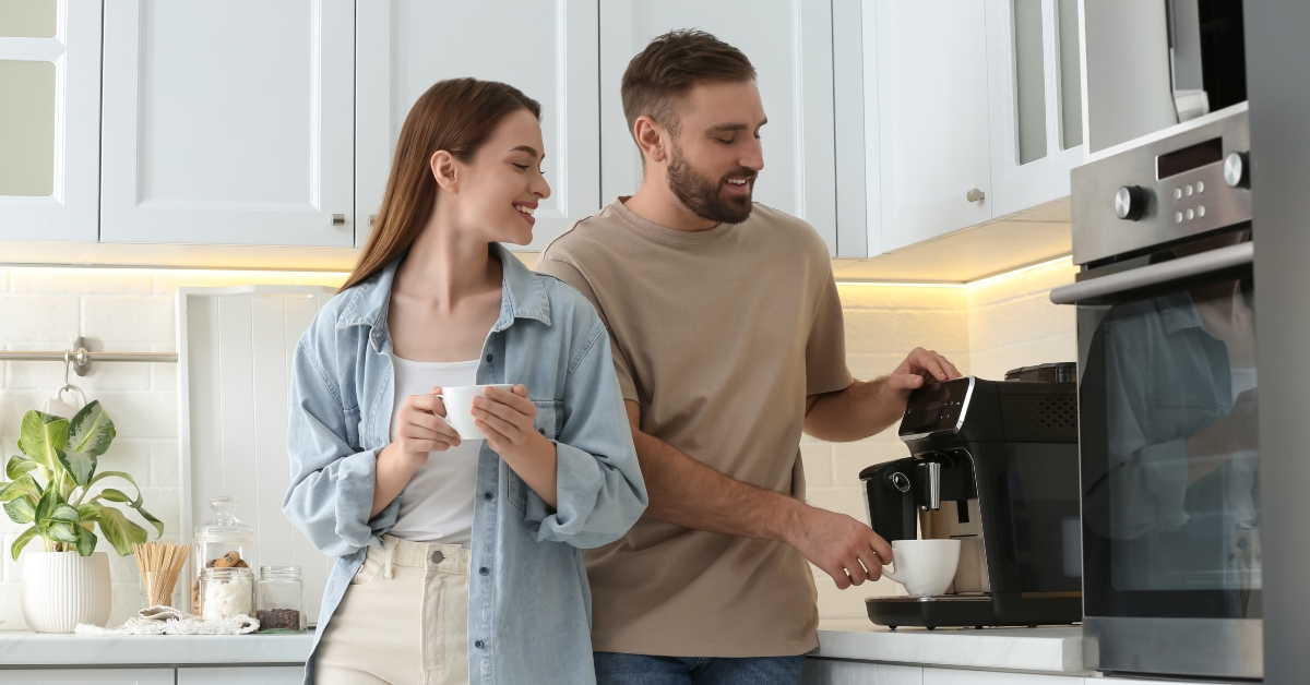 happy couple preparing fresh aromatic coffee