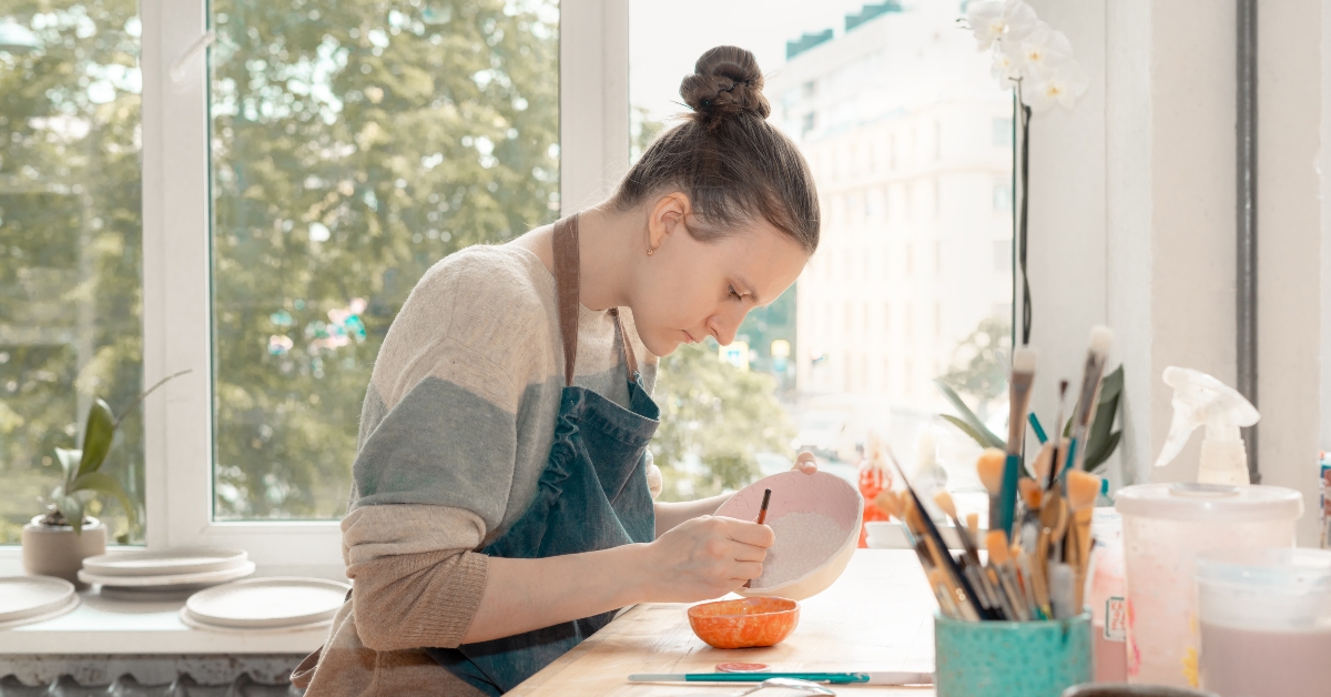 drawing on ceramic bowl in pottery workshop