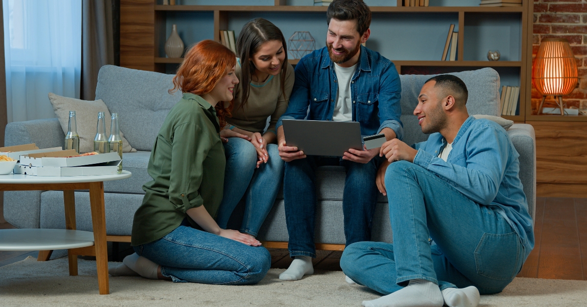 friends sit in living room work with laptop
