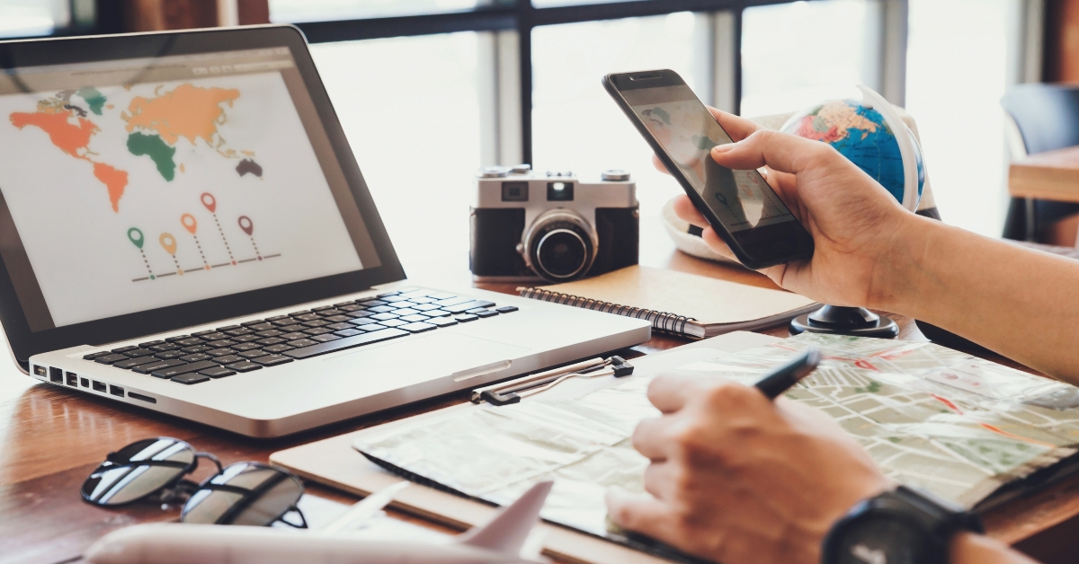 man using smartphone planning vacation 