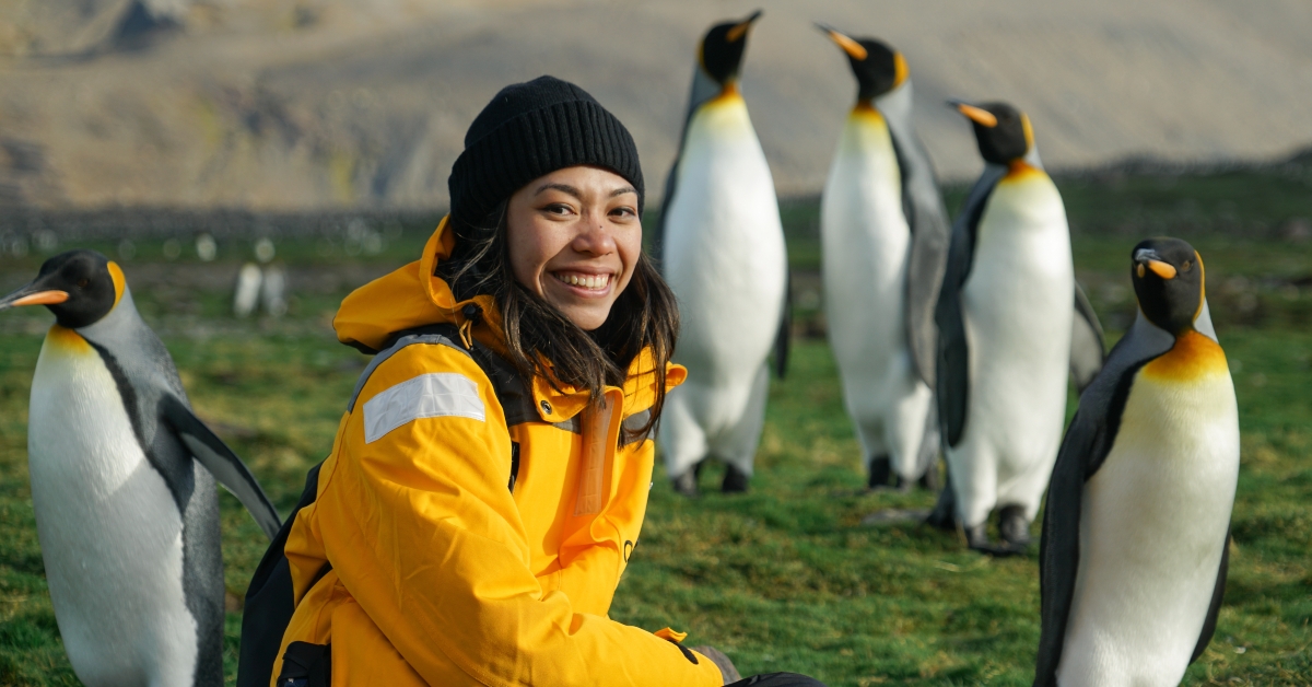 woman with penguins in background