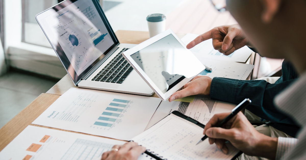 business partnership coworkers using a tablet to analyze graph