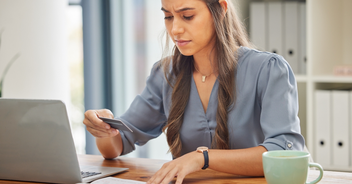 businesswoman in office holding a credit card