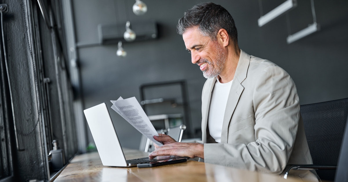 executive manager wearing suit sitting at desk in office