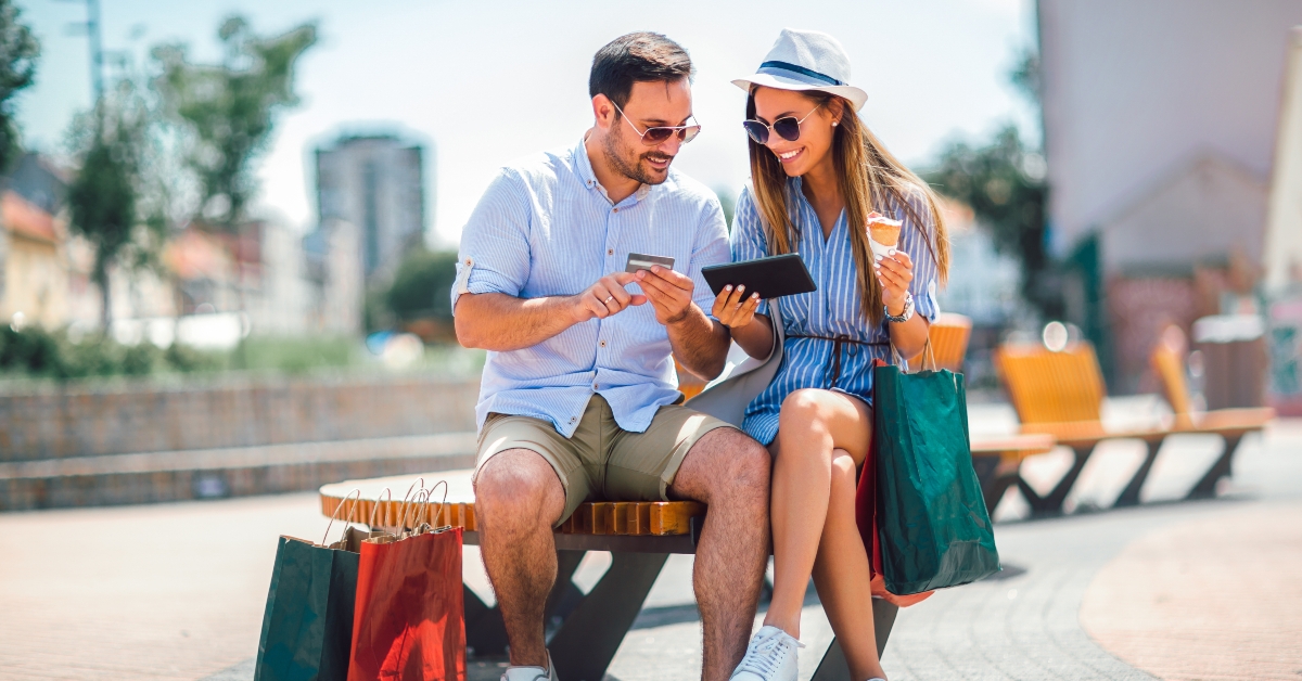 happy couple paying on line with credit card and digital tablet