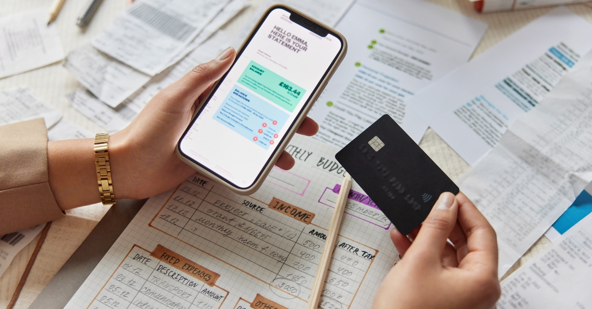 woman holds mobile phone and credit card