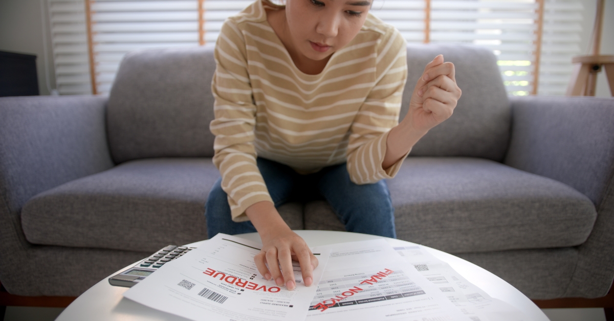woman looking at overdue notices