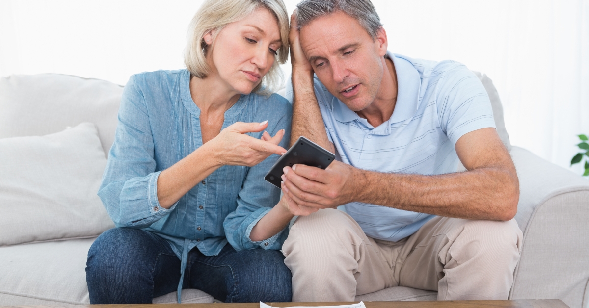worried couple going over their debt 