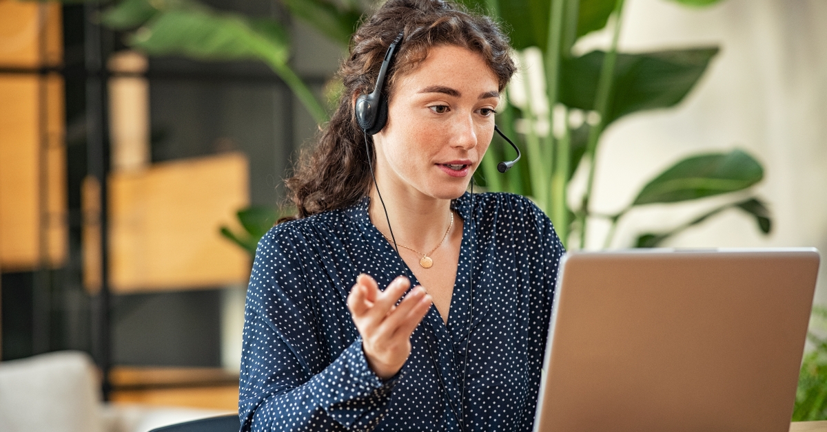 young woman on video call using laptop at office