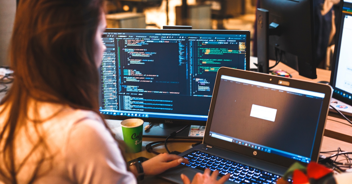 programmer girl works at the computer