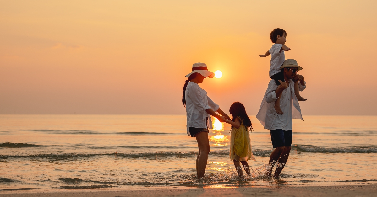 asian family that enjoys beach activities