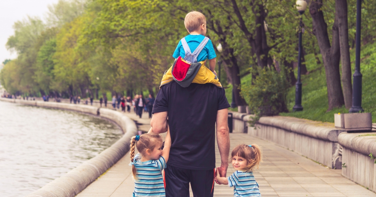 father with his children taking the walk