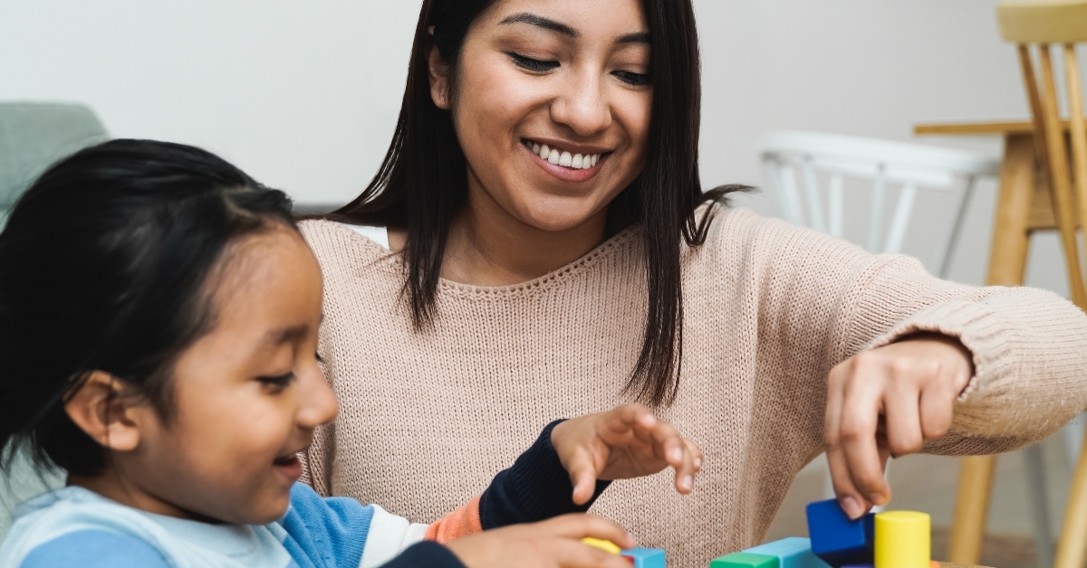 mother and son child playing games with wood toy bricks