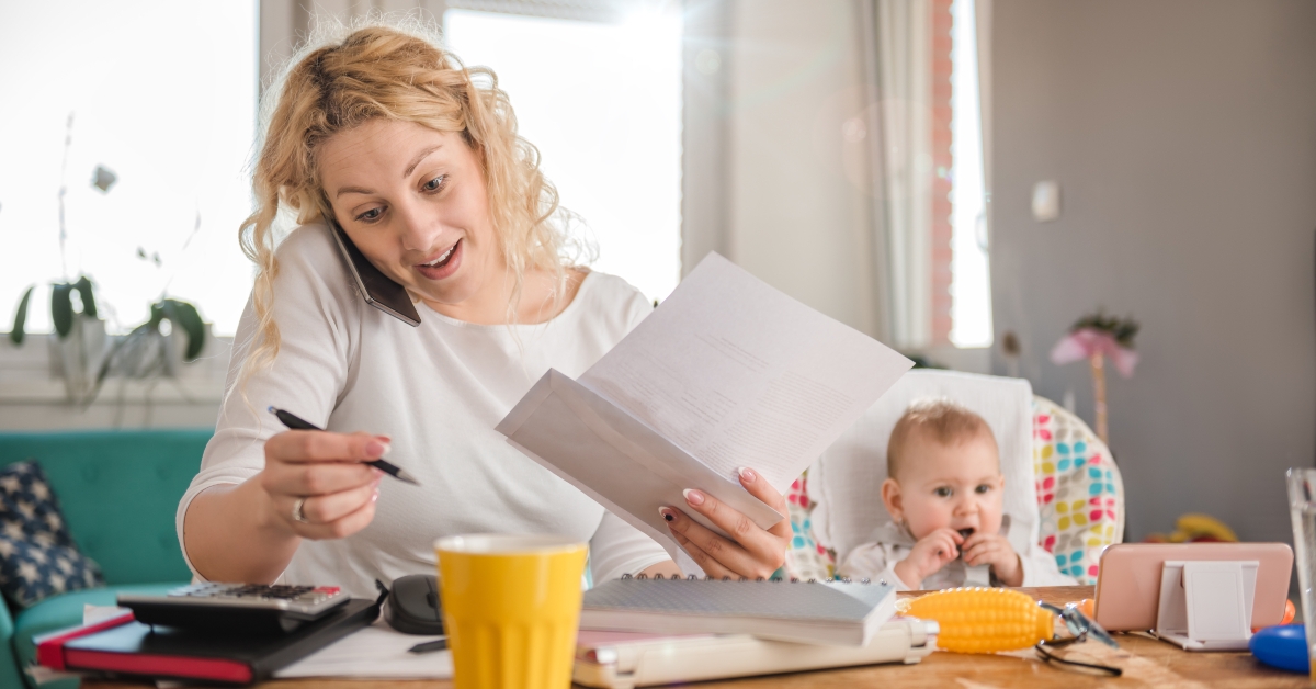 mother talking on smartphone at home office