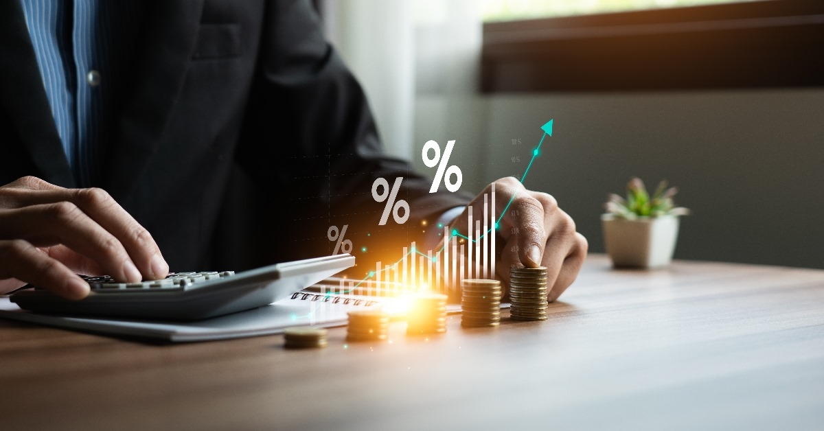 businessman holding a calculator calculating income and return on investment in percentage