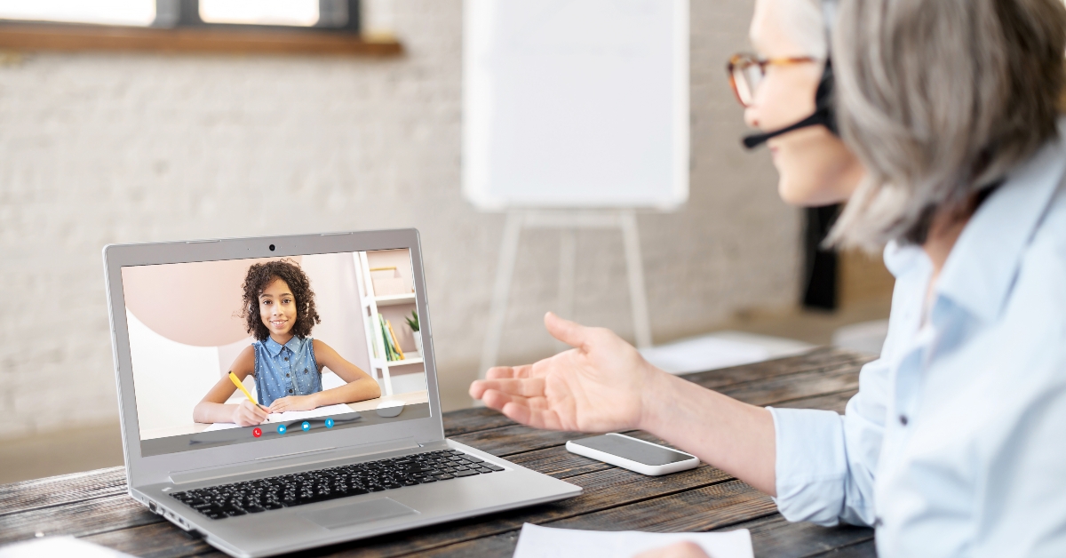 schoolgirl on a laptop screen is listening attentively to the teacher