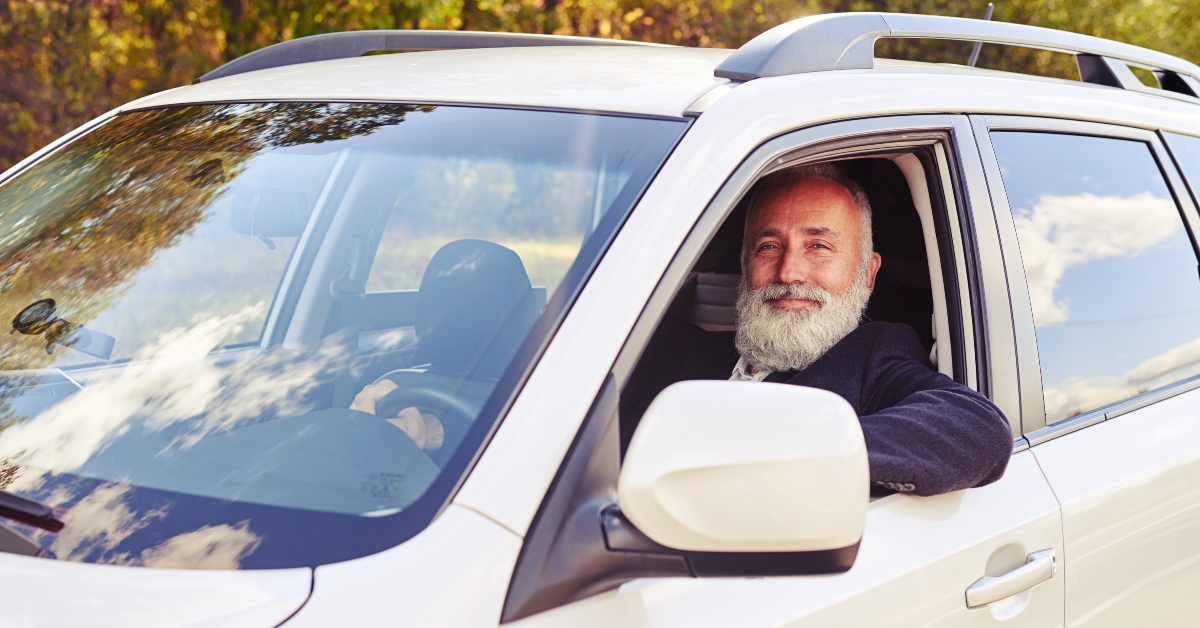 successful senior businessman looking from window