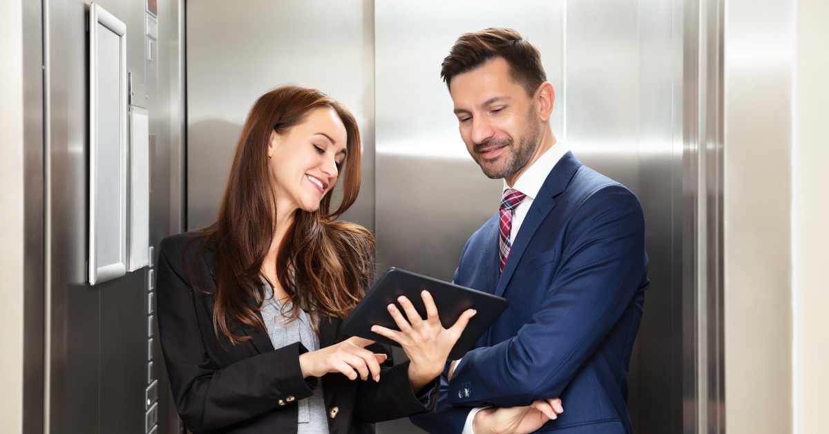 businesspeople discussing standing near elevator
