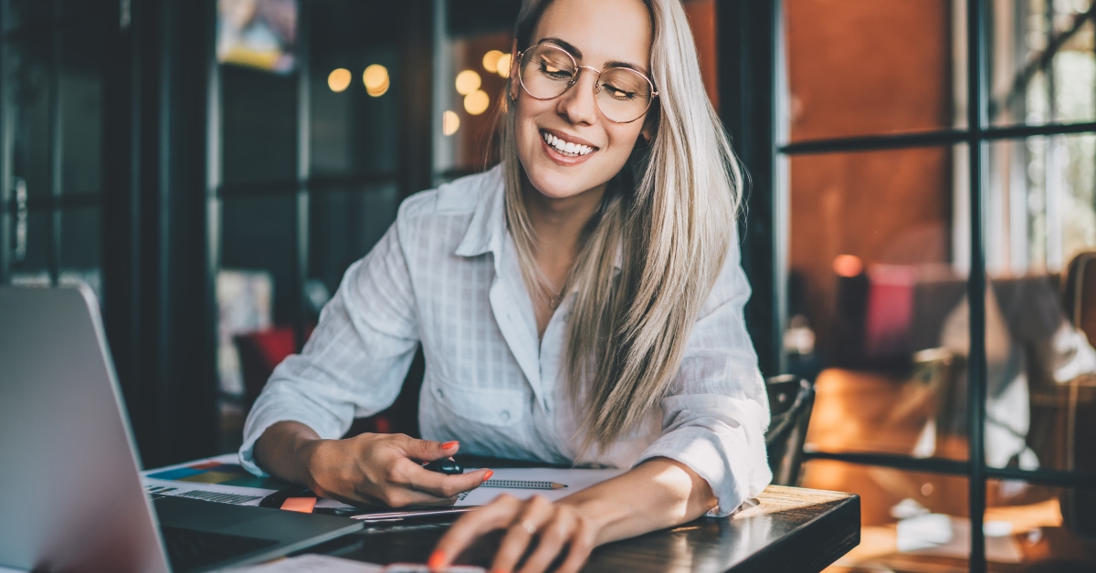 cheerful freelancer checking notifications on smartphone