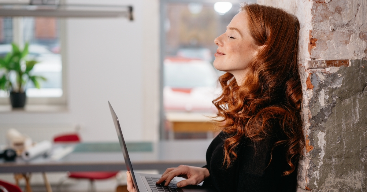 redhead woman standing daydreaming