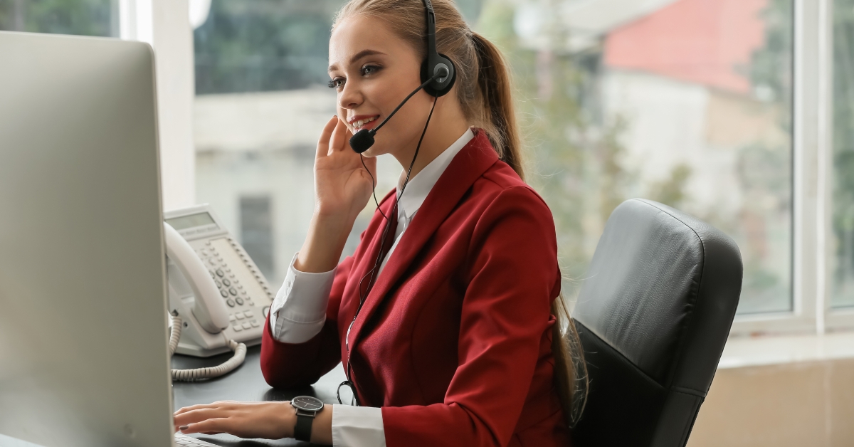 secretary talking through headset in office