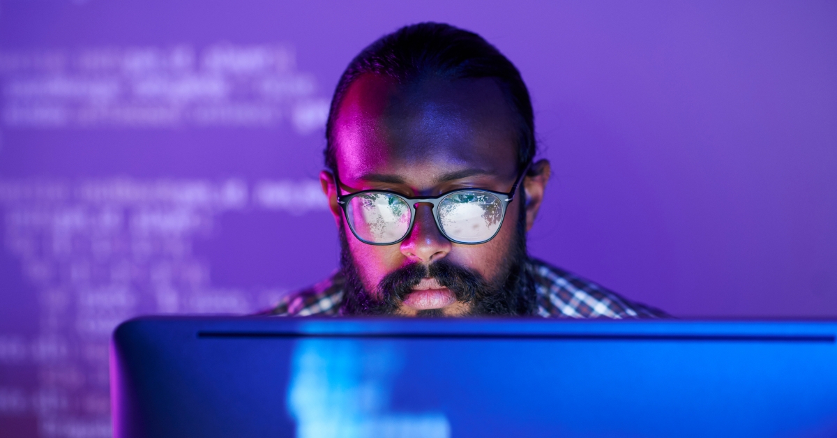 programmer in eyeglasses concentrating on working with coded data