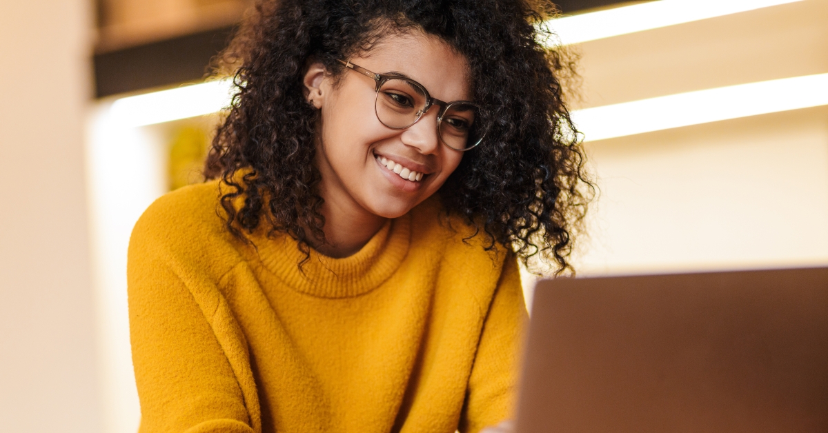 woman in eyeglasses using laptop