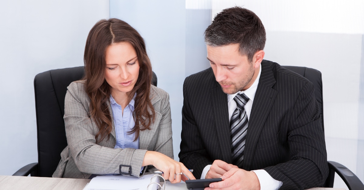 business team calculating finances at work with documents on the table
