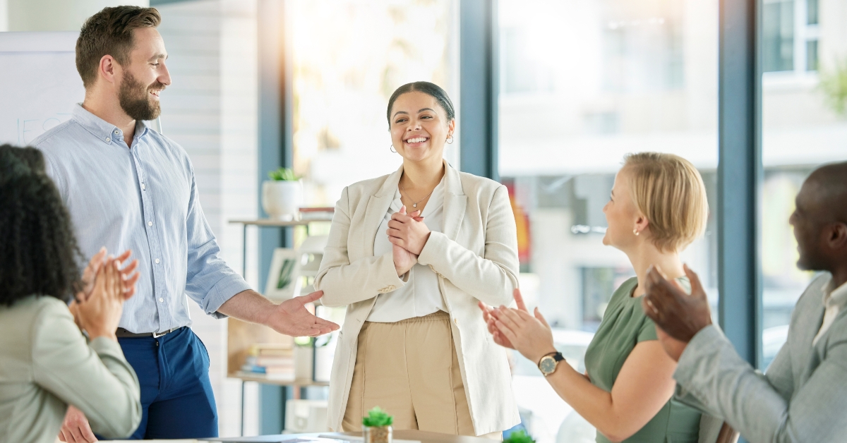 businesspeople clapping for employee growth