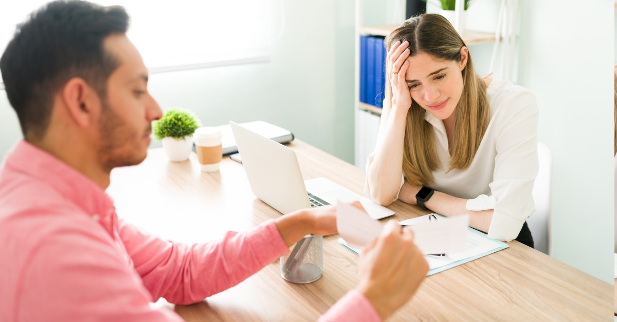 female boss acting angry at male employee showing papers