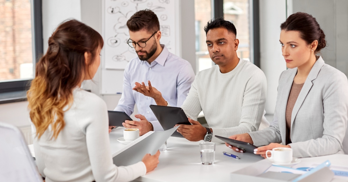 asian woman in interview with team of recruiters
