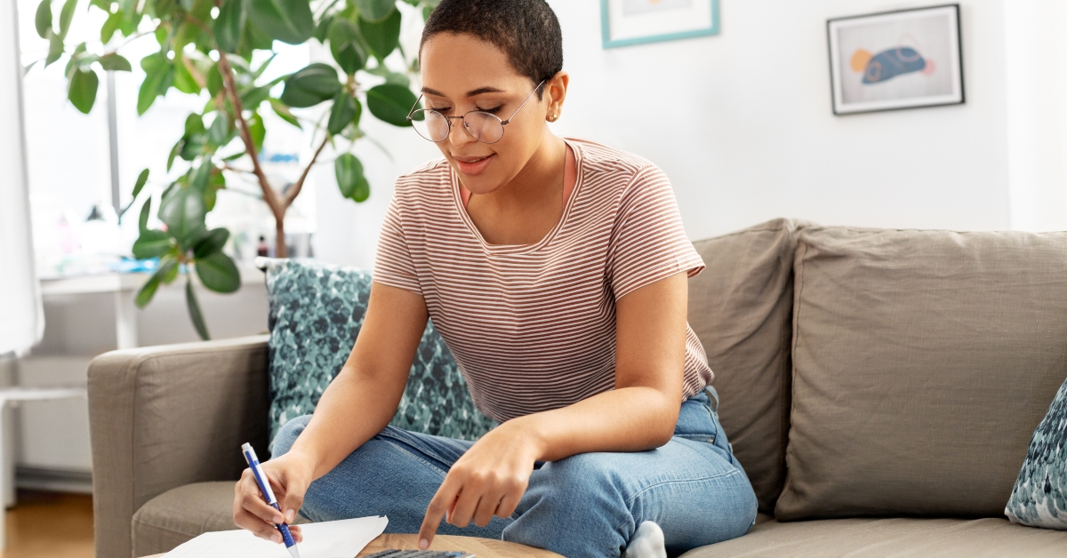 woman in glasses with papers and calculator