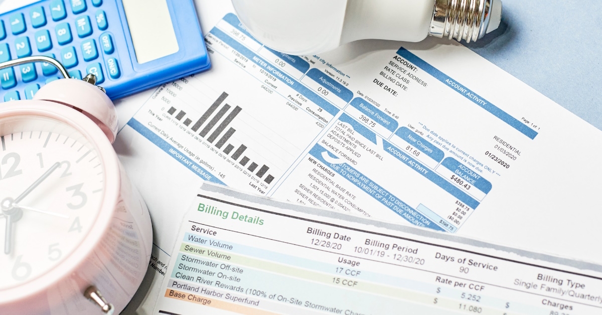 utility bills scattered over table 