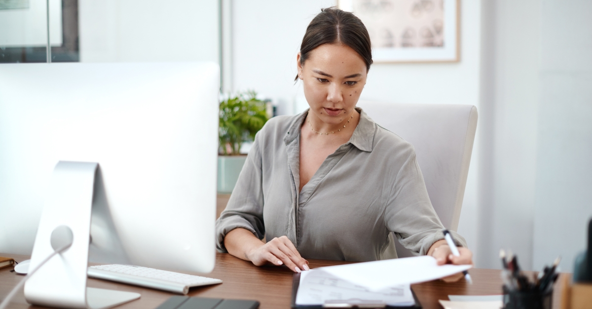 asian businesswoman reading paperwork