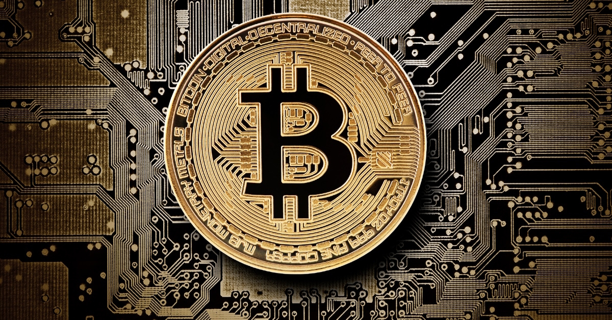 bitcoin golden coin on circuit board of computer