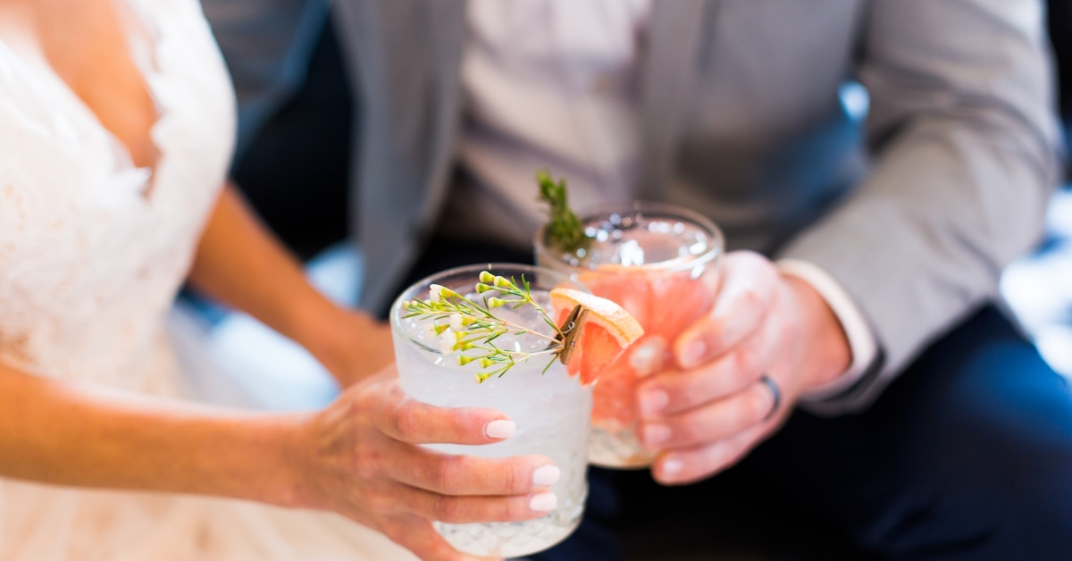 couple toasting with mocktail glasses at a wedding celebration