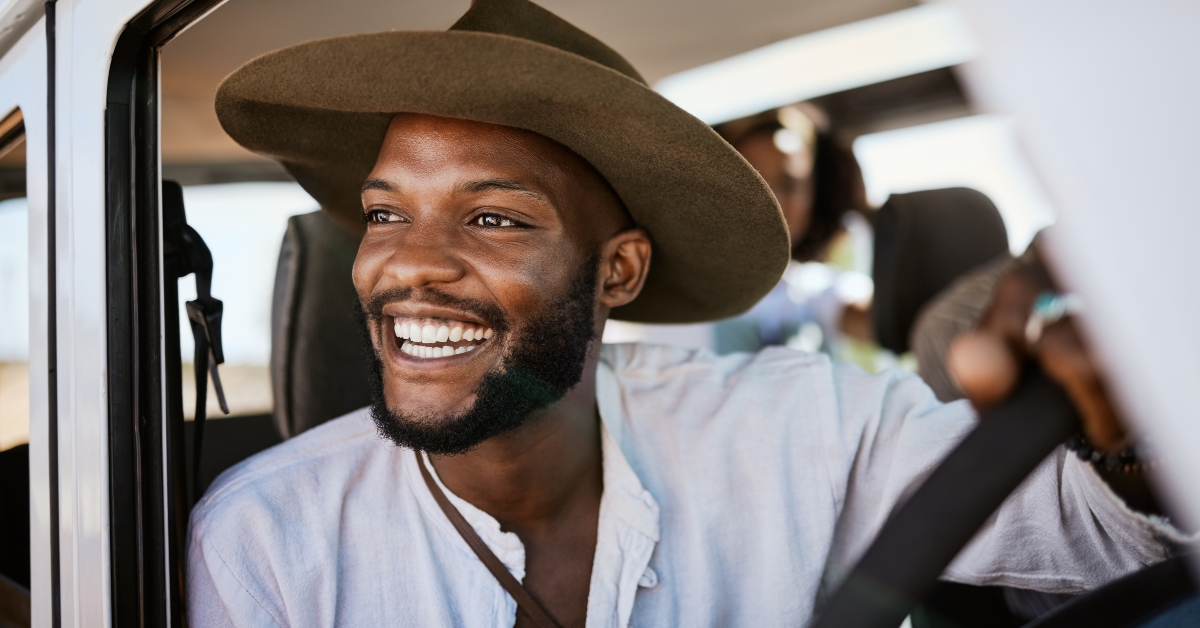 black man driving and enjoying career