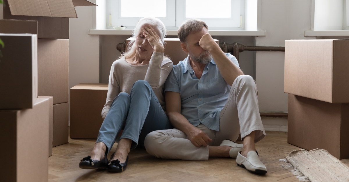 elder couple of homeowners exhausted with relocation